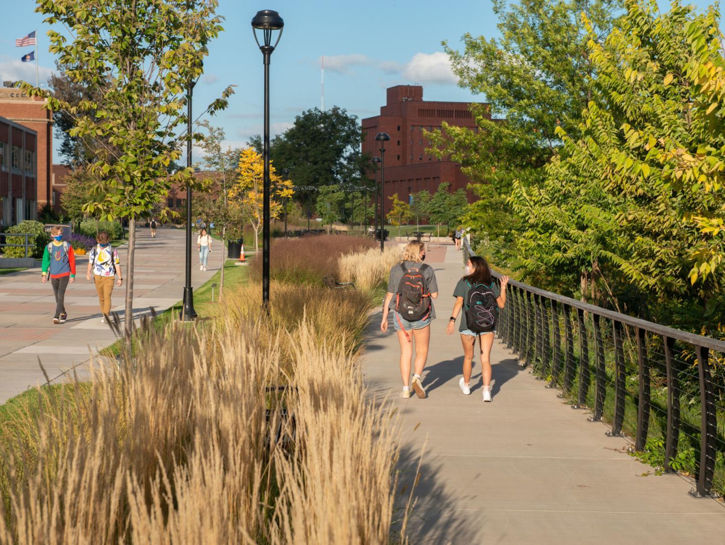 Students walking with masks on outside