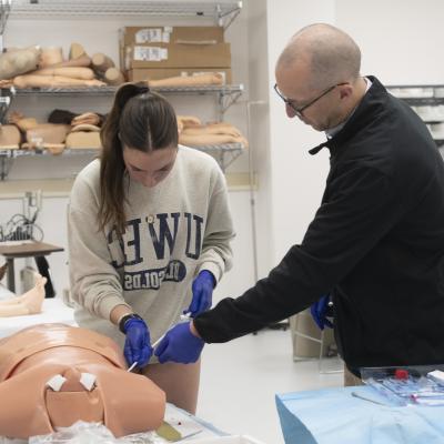 student in procedural skills lab learning chest tube 